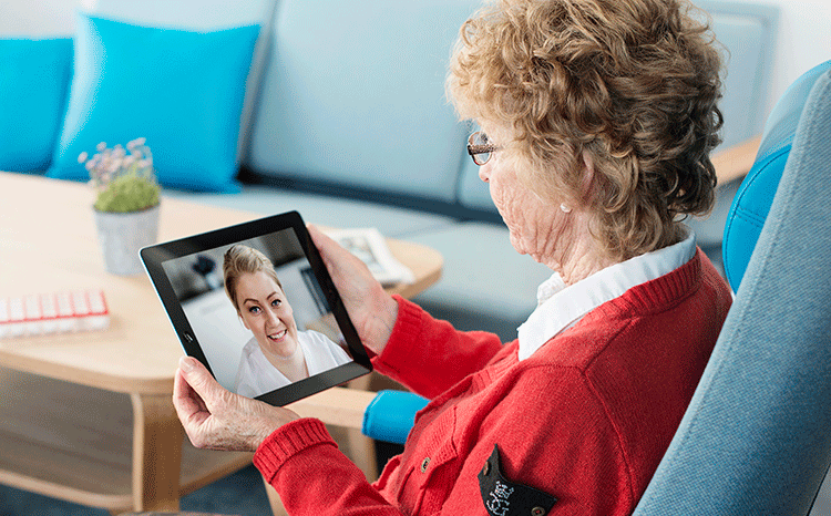 elderly person holding iPad