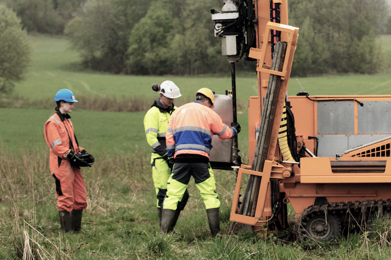 Photo. Geotechnical Engineers in field lab using drilling rig.
