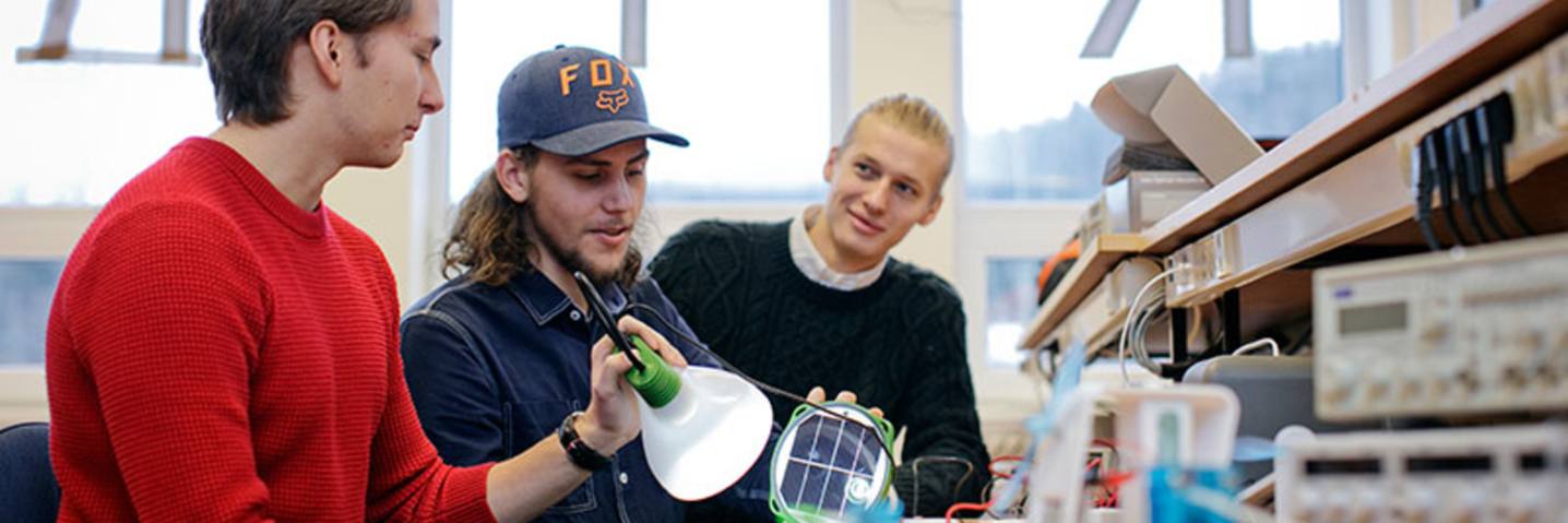 Picture of students with solar panel equipment
