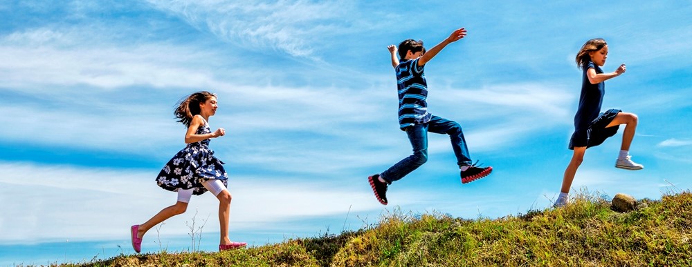 Children running on a hill. Photo: iStock