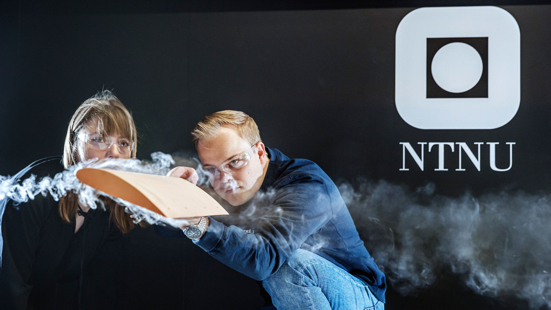 students in the wind tunnel with smoke visualisation of wind around air foil. photo