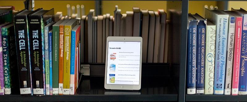 Close up of book shelves with ipad