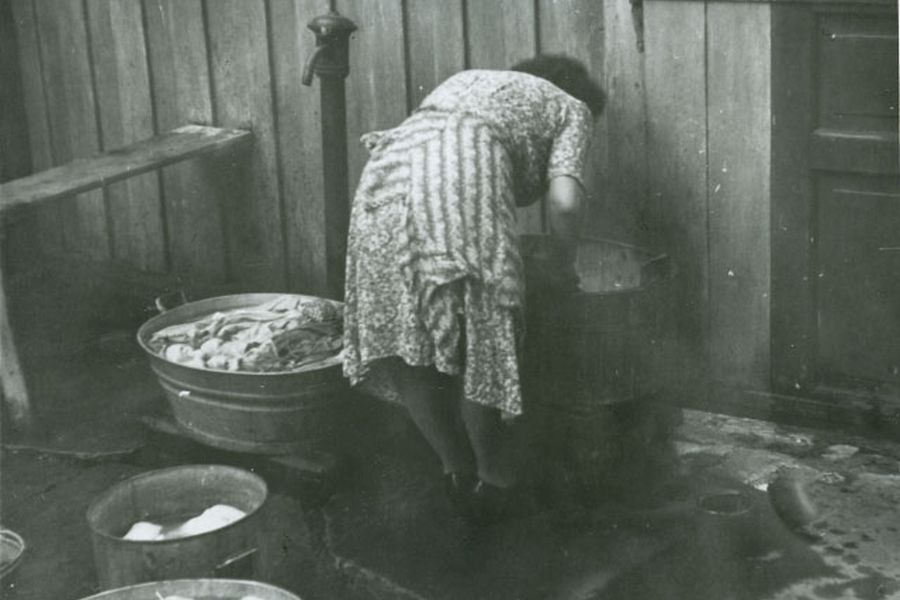 Woman washing clothes in the backyard, Trondheim, early 1950's
