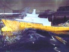 Model ship cresting wave