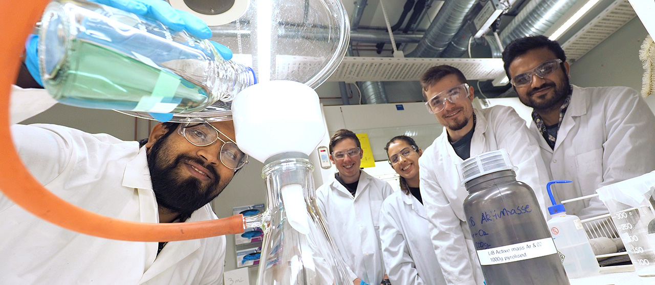Five researchers in a laboratory. Photo
