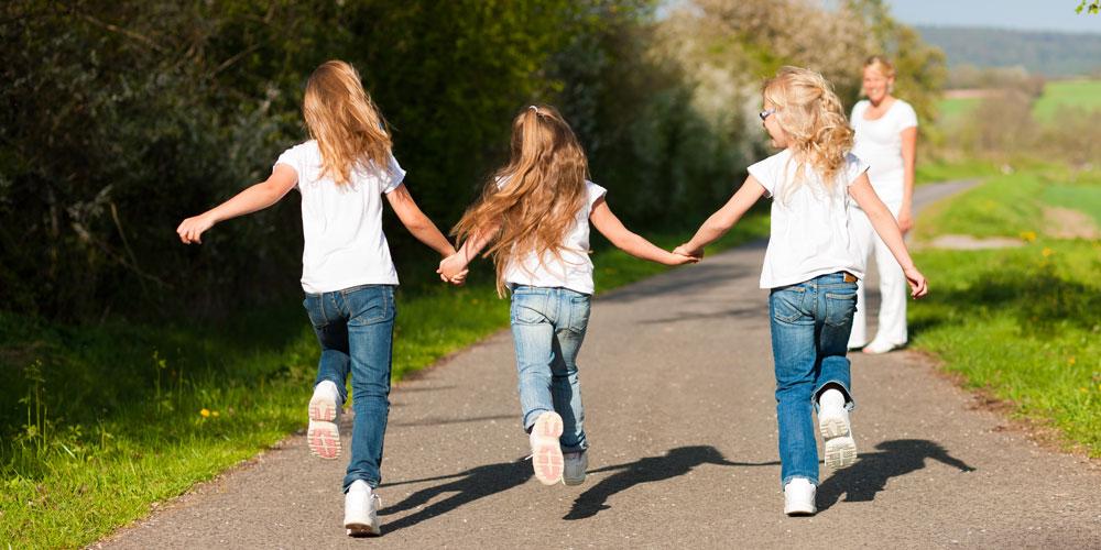 Three girls holding hands