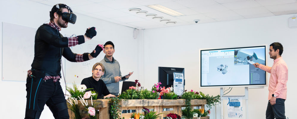 Four students in the Logistics 4.0 lab. Photo: NTNU/Geir Mogen