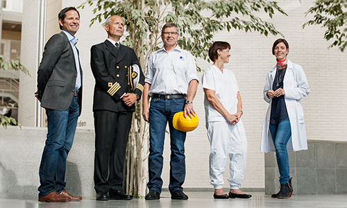 Five faculty representatives wearing representative work-uniforms