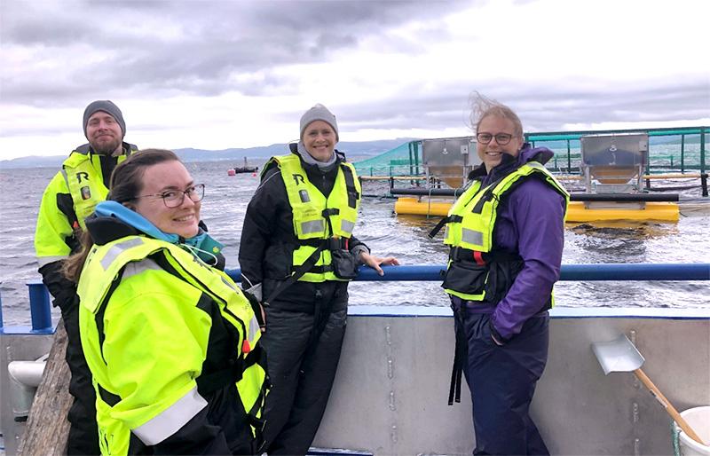 The InnoSEA team on a boat next to a salmon farm. Photo