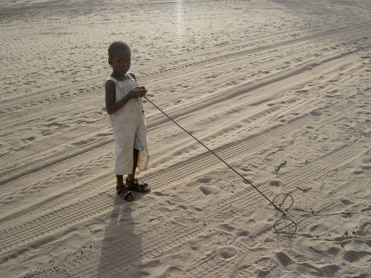 Boy playing in the dessert. Photo