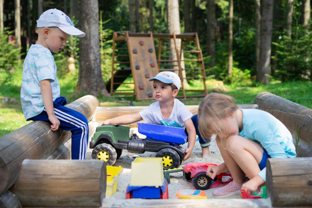 Children playing with cars in a sandbox. Photo