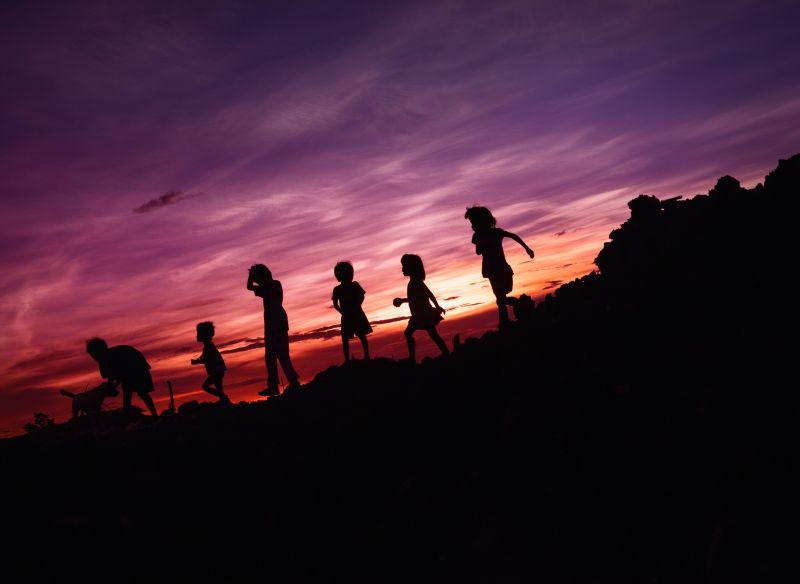 Children's silhouettes in the sunset. Photo