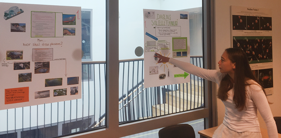 A student presenting two posters. Photo.