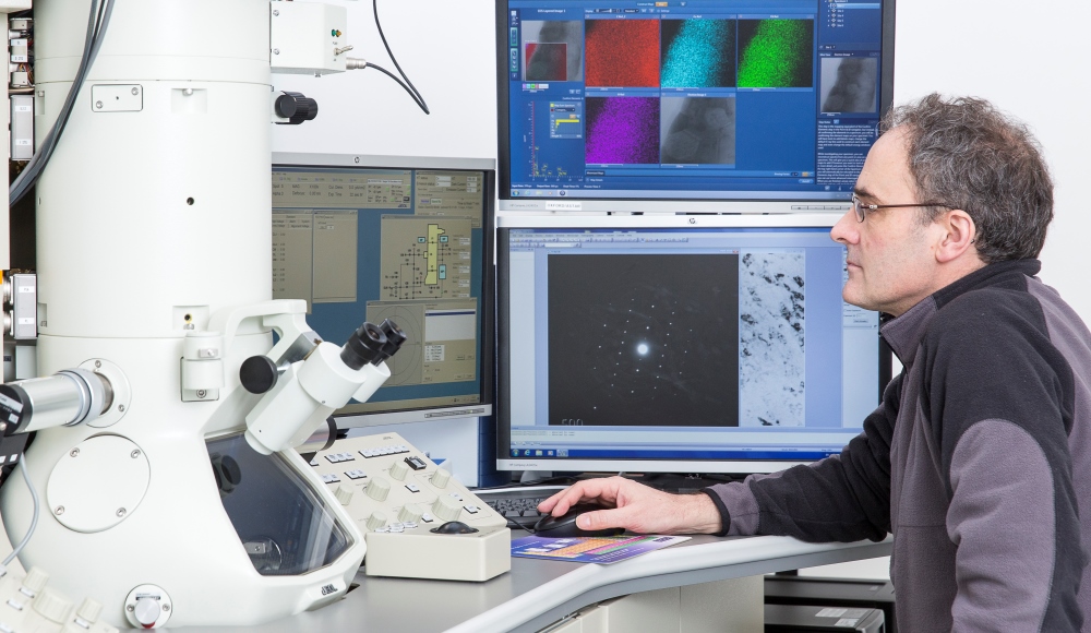 Researcher in front of a microscope. Photo