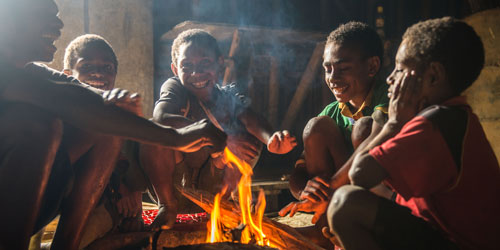 Boys around fire in Papa New Guinea