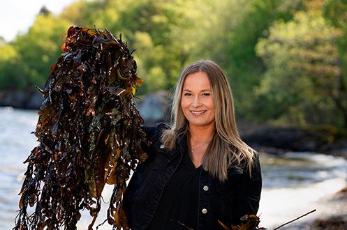 Portrait of Celine Sandberg, holding seaweed.