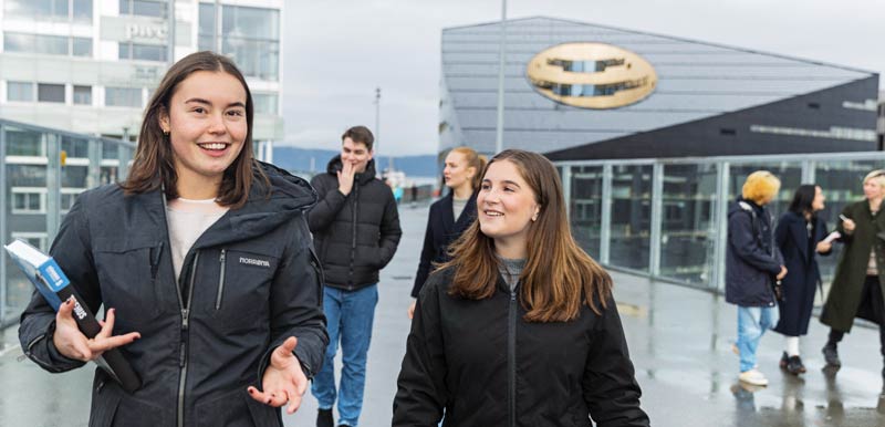 Students out walking in front of buildings.