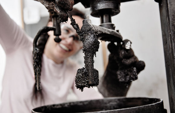 Photo. Female researcher using asphalt blender.