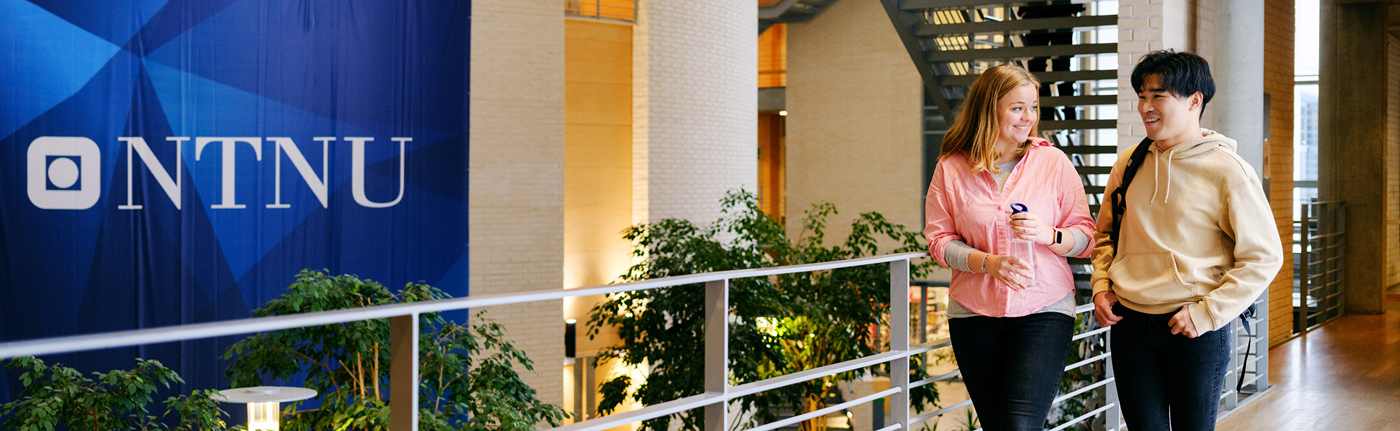 Two NTNU students on campus. NTNU logo beside.
