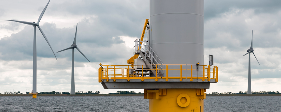Picture of an oil platform and three wind turbines