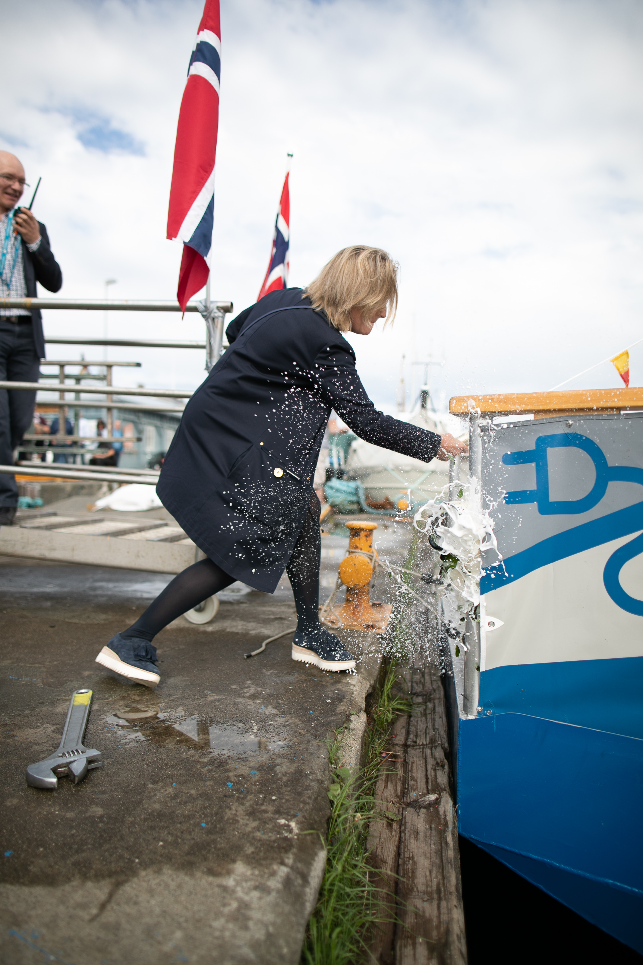 The ferry's godmother, Ingrid Schjølberg performs the christening by the traditional breaking of a bottle of champagne.