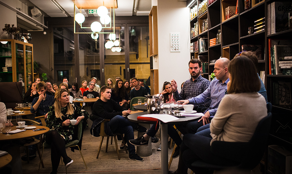 Audience and panelists at a debate meeting