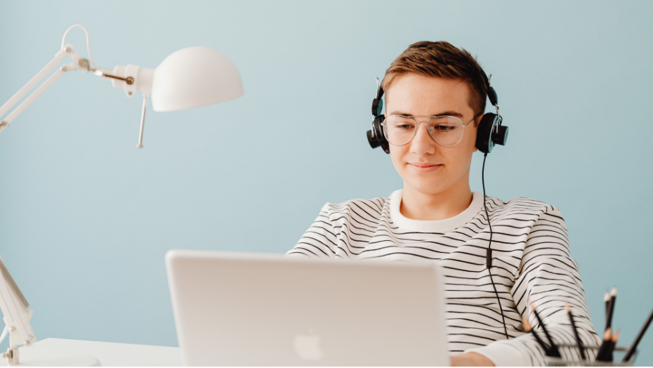 Person sitting in front of a laptop.