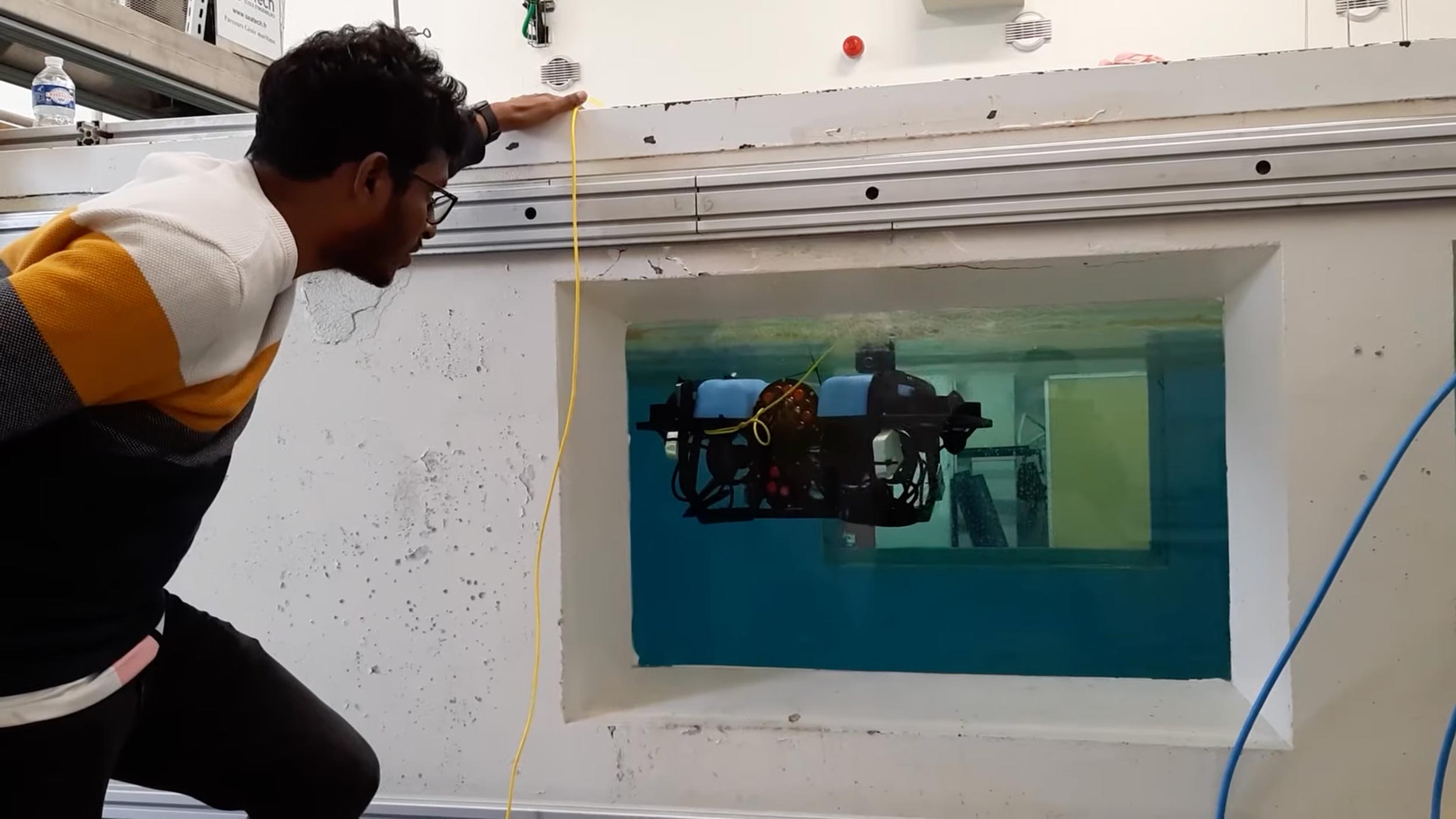 Student watching a model of a underwater robot
