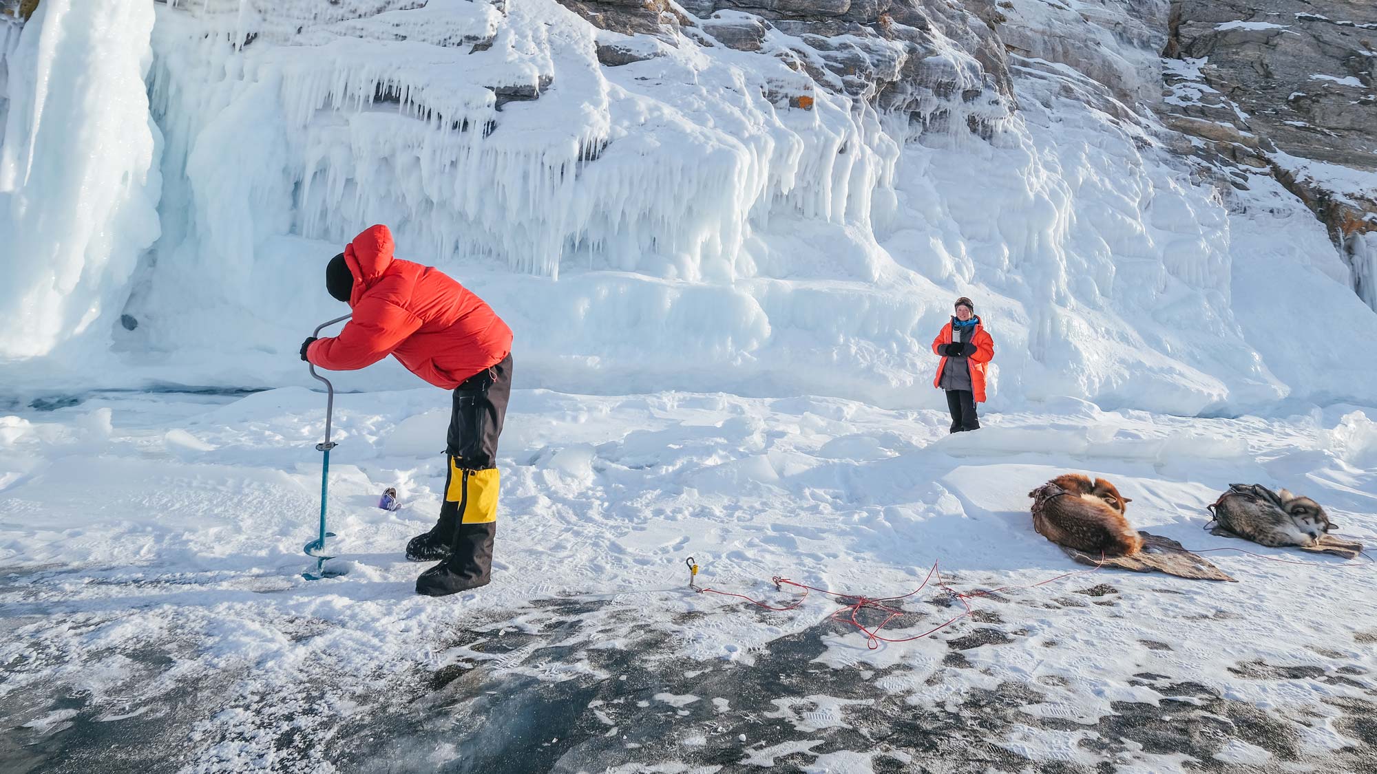 Man drilling in the ice in the arctic