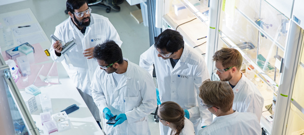 Researchers wearing white coats in a laboratory