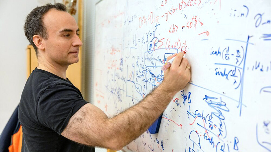Jacob Linder writing a formula on a white board