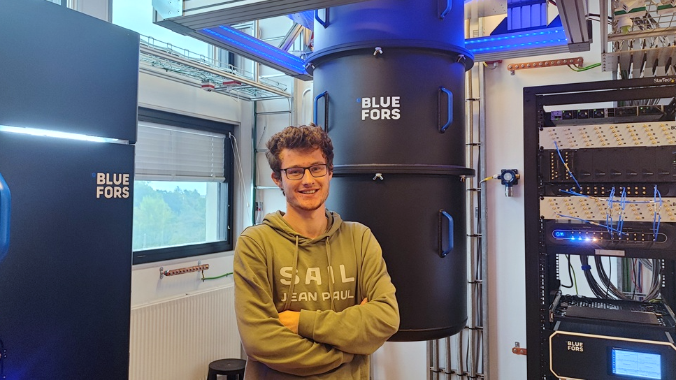 A researcher standing in front of advanced equipment