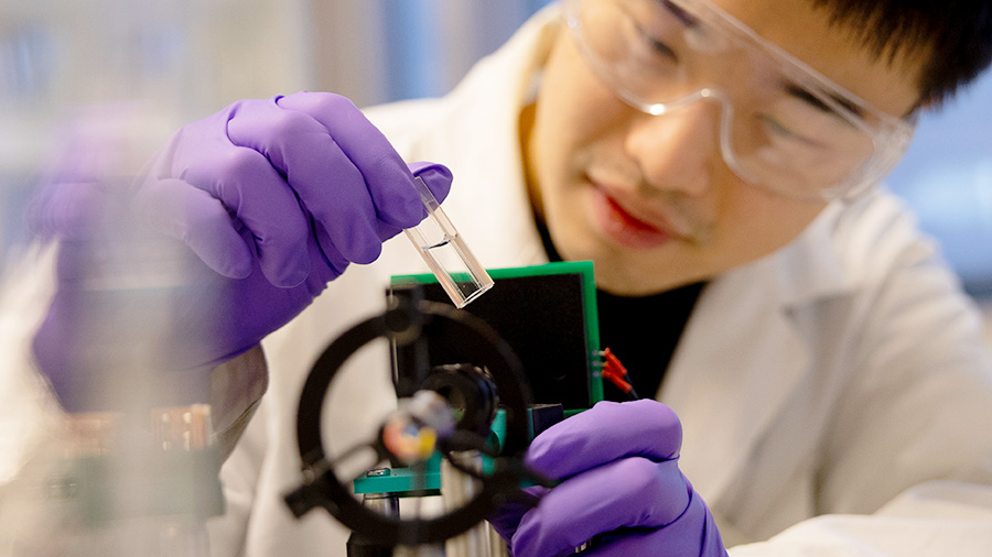 A man looking at a sample in a laboratory