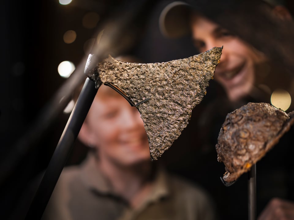 Father and son are looking at a Viking Axe