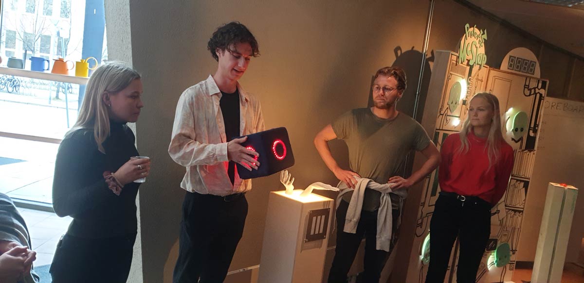 Students presenting their design project; a game to keep fit.