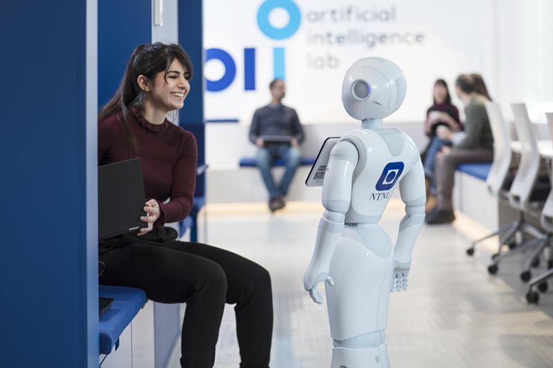 Girl smiling at robot