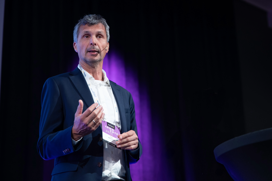 A person in a suit speaking