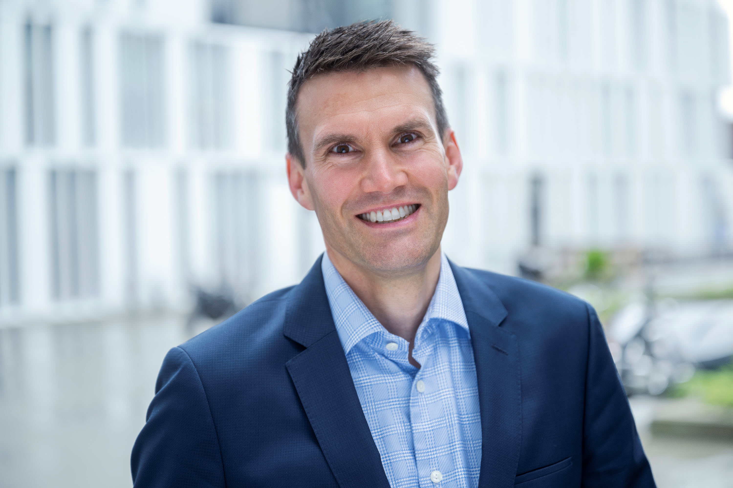 A person in a suit smiling