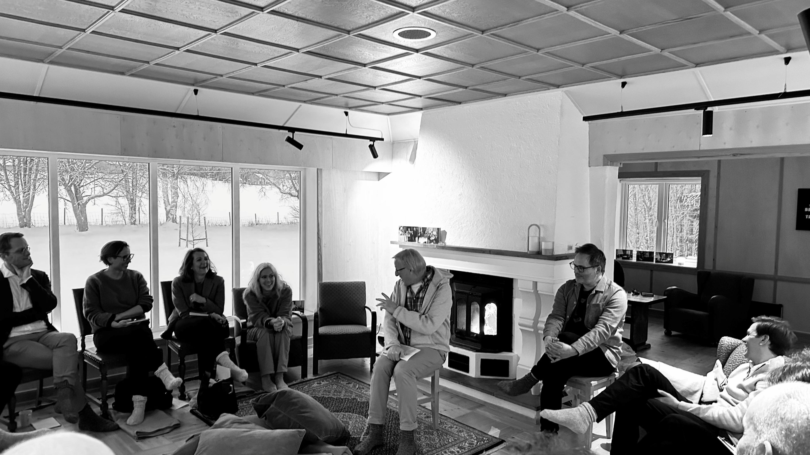 A group of people sitting in a circle, discussing