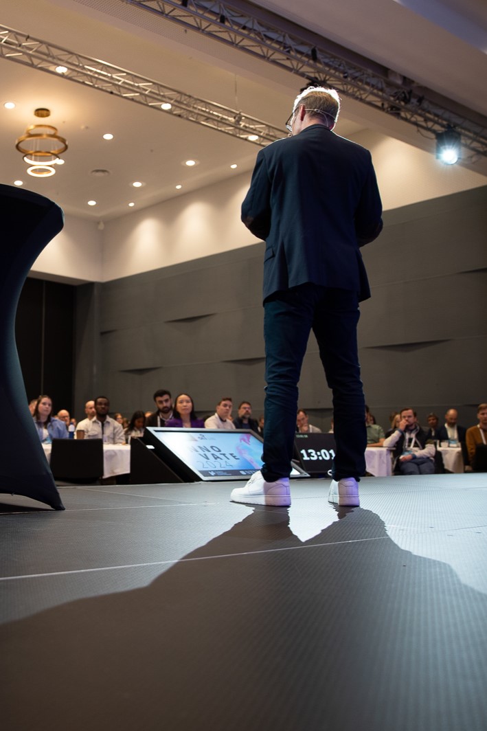 An audience listening on a talk from a stage