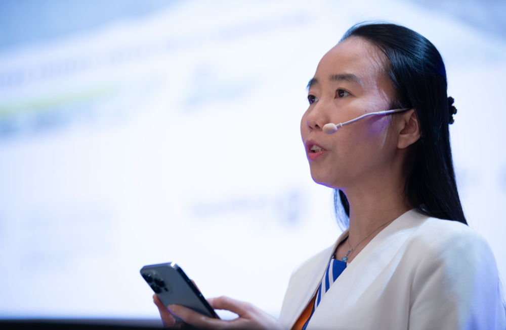 Nhien Nguyen speaking on stage