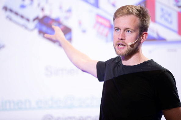 Simen Eide speawking on stage