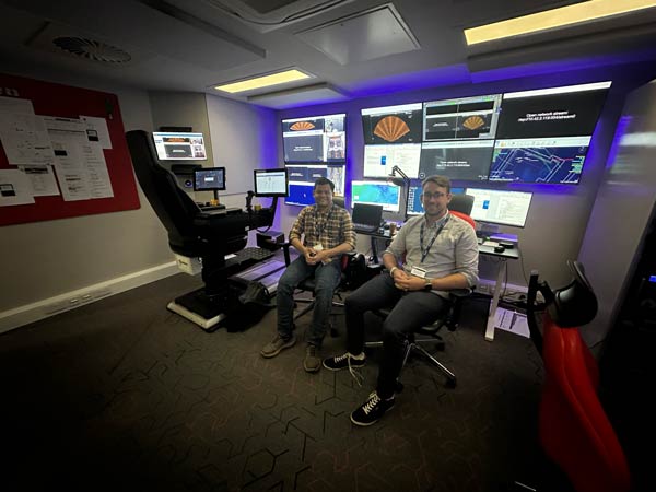 Taufik Akbar Sitompul and Felix-Marcel Petermann, SFI AutoShip researchers, visiting a remote operation centre at Fugro in Aberdeen, sitting in front of the screens and controls.