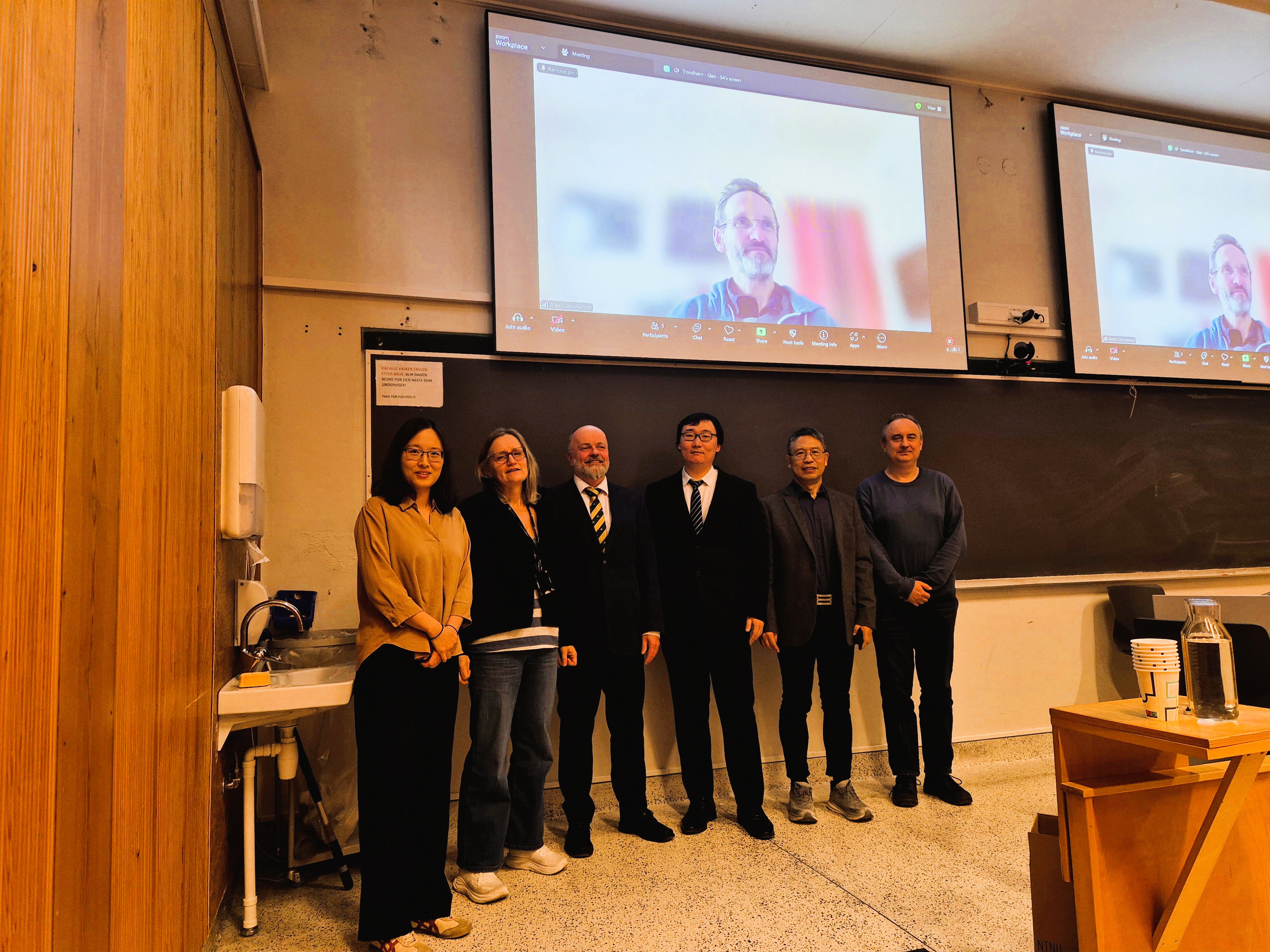 Group photo in front of a blackboard
