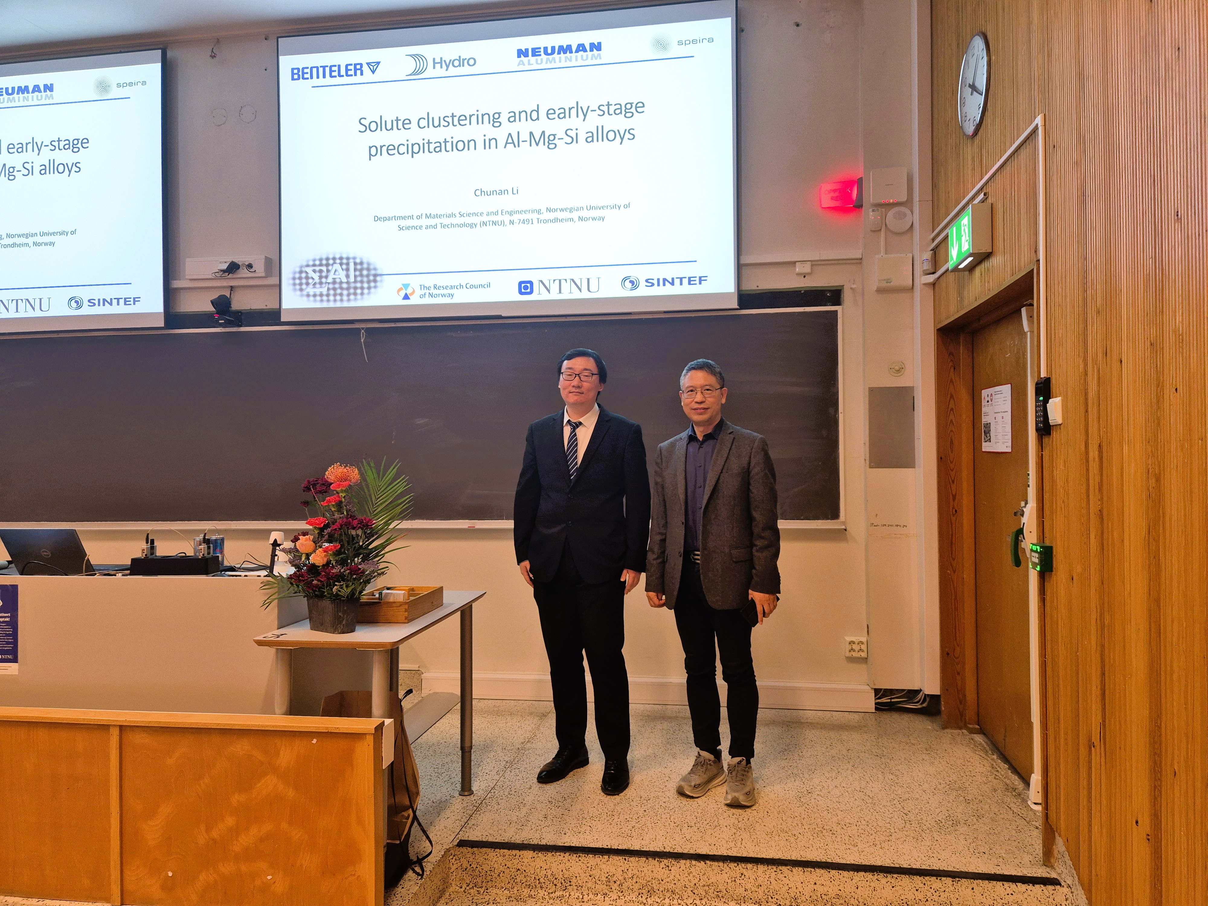 Two men in a lecture hall.