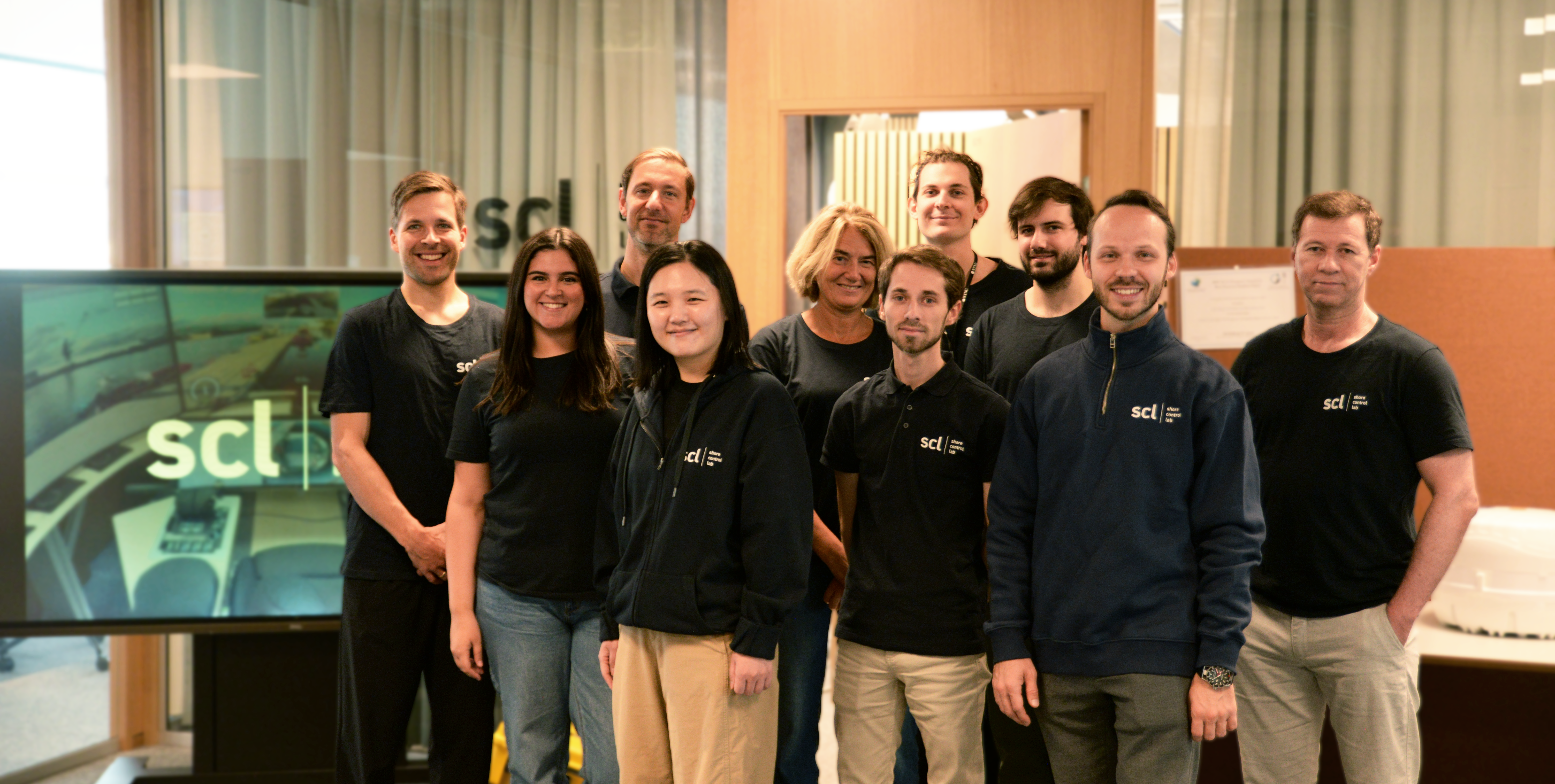 Photo of the current team at shore control lab, inside their office.