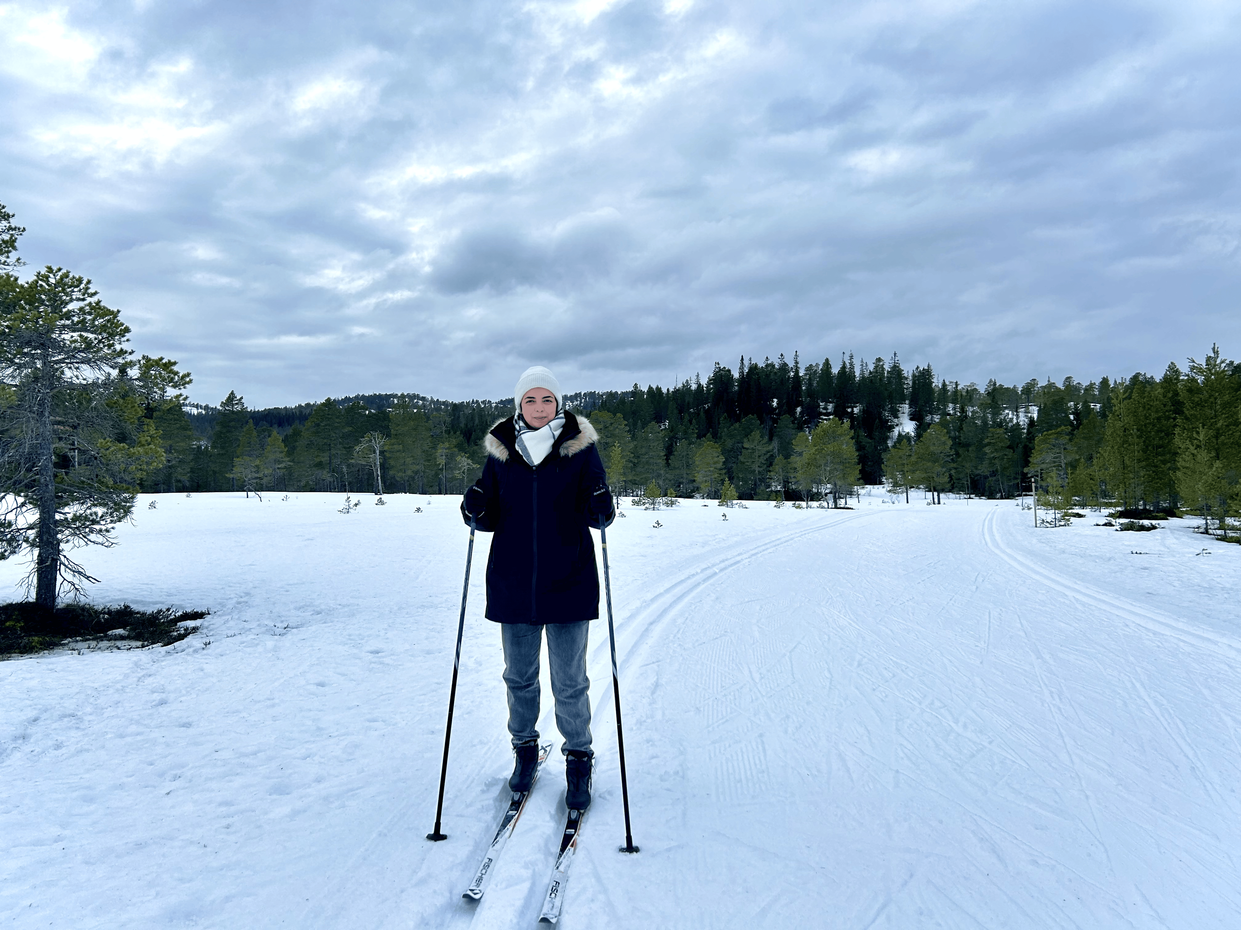 Person standing outside on skies. Photo