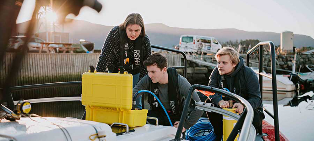  Students looking at the results from tests they have carried out in the fjord.
