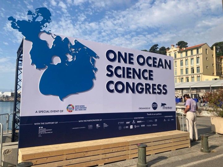 One Ocean Science Conference large sign is displayed outside on a sunny day