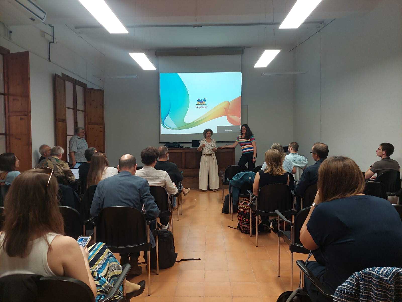 DiverSea team members watch the welcome presentation in an auditorium